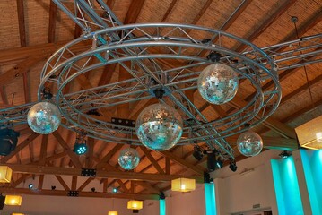 Close-up of disco balls and strobe lights hanging from the ceiling