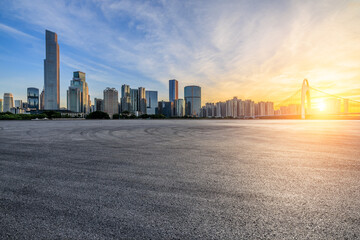 Asphalt road square and city skyline with modern buildings scenery at sunset