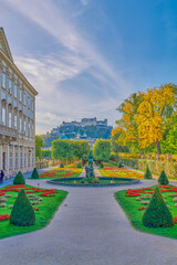 Salzburg, Austria -  October 6, 2022: The garden of the Mirabell palace with the old town and the Hohenslzburg fortress in the background