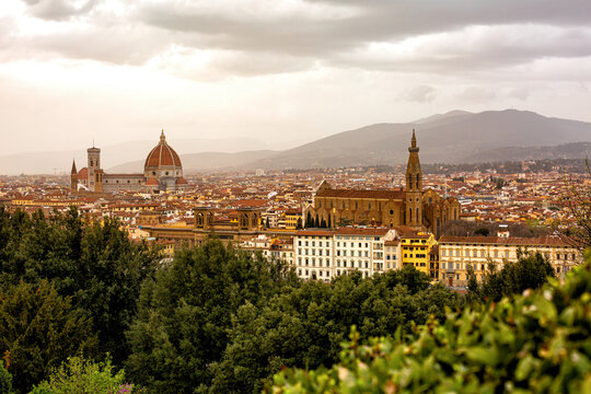 Panoramic View  of Florence or Firenze,  Italy. Cityscape in a cloudy early spring evening, green park on  foreground and mountains on a background. 2024-03-31.