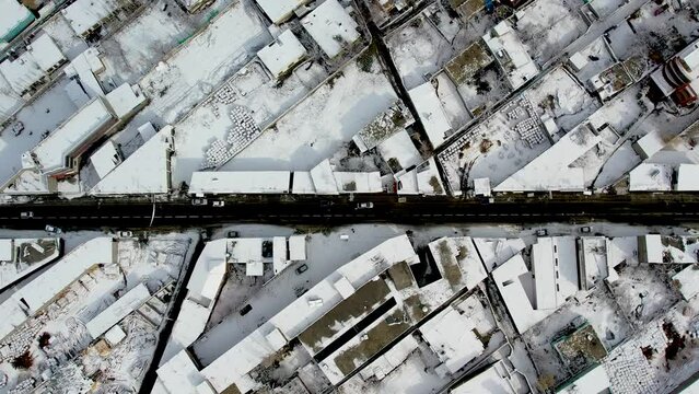 Aerial top view of crowded Skardu city covered with snow in Pakistan.