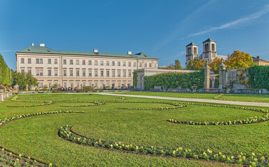 Salzburg, Austria -  October 6, 2022: The  Mirabell palace and garden with the St Andrew bell tower in the background