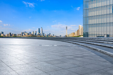 Empty square floor and glass wall with modern city buildings in Guangzhou