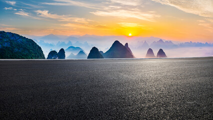 Asphalt highway road and karst mountain with sky clouds at sunrise