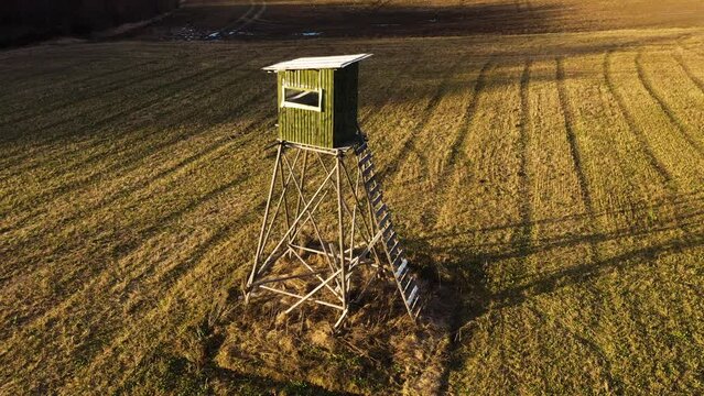 Wooden hunting tower in aerial parallax shot