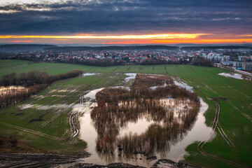 Amazing sunset over the wet spring fields in Poland