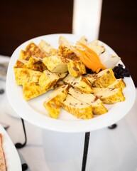 Vertical shot of the sliced meatcake on the white plate prepared for a banquet