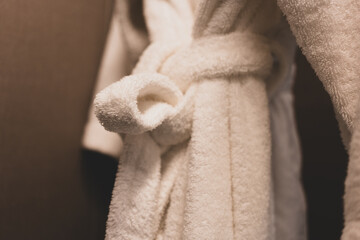 Close up of soft terry cloth spa bathrobe on the hanger
