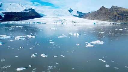 Aerial view of the Fjallsarlon lake covered in ice pieces in Iceland