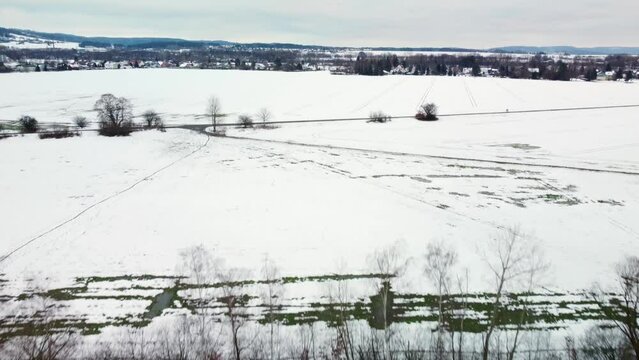 Aerial drone footage of a snowy field