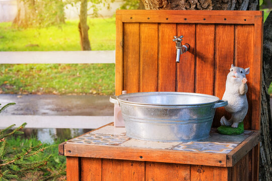 Washstand in village in outdoor. Washing hands in rustic garden in sunny day. Countryside.