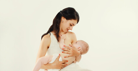Happy mother breastfeeding her baby on white background