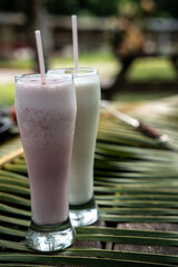 Beautiful shot of pink and white smoothies in a glass