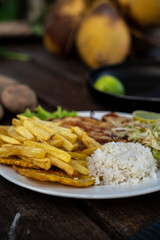 Beautiful shot of chicken, fries, rice and cabbage salad in a plate