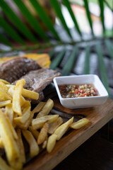 Plate of grilled beef steak with fried potatoes