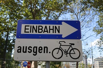 Traffic sign in Austria indicating a one way street with an arrow pointing right above a bike sign