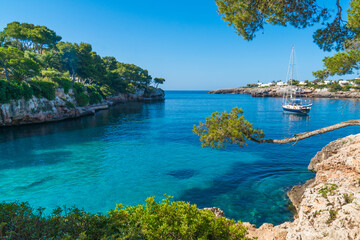 Playa de Cala Serena beach view on a sunny day, green vegetation around © Wirestock