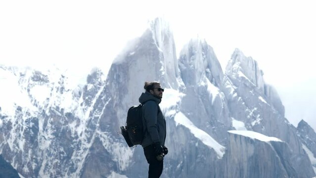 Filmmaker looking to the Cerro Torre in Chaltén, Patagonia, Argentina.