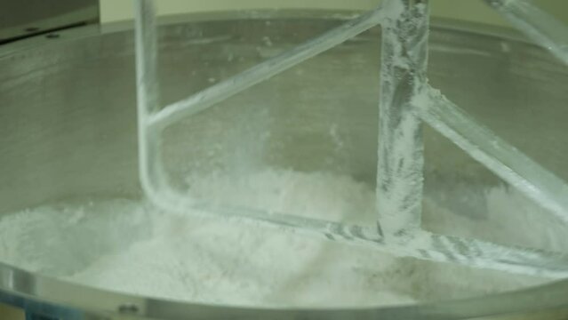 A laboratory planetary mixer mixes the chemical components.