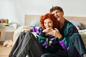 alluring cheerful girlfriend and boyfriend in stylish outfits hugging each other while at home - obrazy, fototapety, plakaty