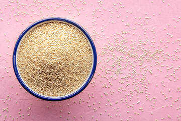 Quinoa in a bowl, healthy organic wood, uncooked, shot from the top with copy space