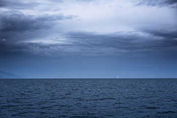 Lonely sailboat in the sea at a stormy weather
