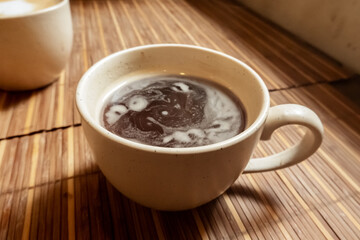 Americano coffee in a cafe, an atmospheric photo of a cup of black coffee in the morning