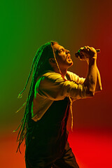 Talented man, soulful musician with dreadlocks expressing his deepest emotions through his singing...