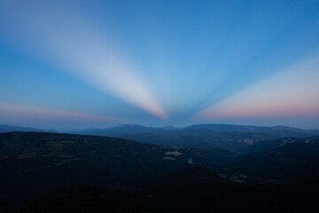 Sunset with anticrepuscular rays in the Sierra del Cadi, Pyrenees, Spain - obrazy, fototapety, plakaty