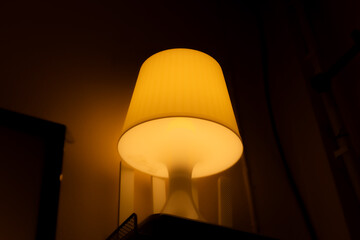 The mushroom-shaped lamp is activated. located in the room