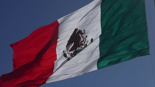 A mexican flag waving a day before total eclipse in Mazatlan, Sinaloa