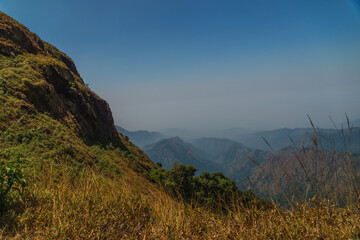 A mountain range with a clear blue sky in the background
