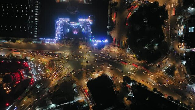 Aerial view of a busy road intersection in front of Chhatrapati Shivaji Maharaj Terminus train station in Mumbai, Traffic at CST Station. Shot of Mumbai Skyline, high-rise buildings in South Mumbai. 