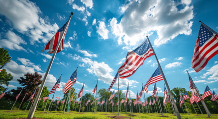 A field of American flags blowing in the wind against a blue sky background. Holiday concept for 4th of July, President's Day, Independence Day, US National Day, Labor Day, Fourth of July