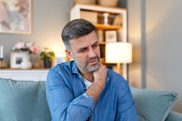 Young man with shoulder pain. male holding his painful shoulder. man hand holding his shoulder...