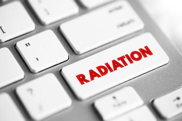 Radiation is energy that comes from a source and travels through space at the speed of light, text concept button on keyboard - 779640186