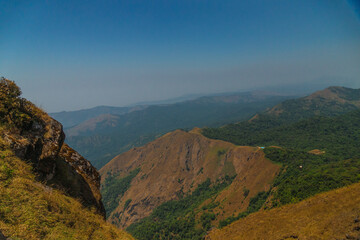 A mountain range with a clear blue sky in the background