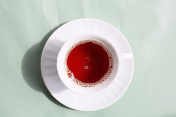 cup of hot black tea on a bright spring colors background
