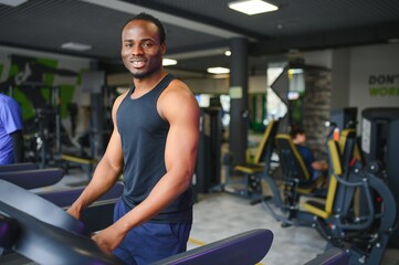 Sports, fitness, healthy lifestyle. African man in the gym.