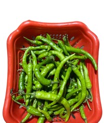 green chilli peppers in red basket 