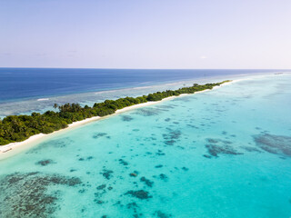 Aerial view of the Dhigurah island in the Maldives famous for its long white sand beach lined with palm trees in the south Ari atoll