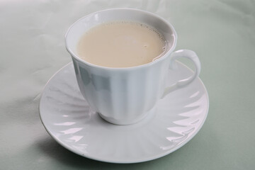 cup of royal milk tea on a bright spring colors background
