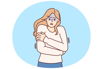 Freezing woman hugging shoulders trying to keep warm and feeling chills after contracting flu infection or fever. Freezing girl in sweater dreams of warm house to wait out cold weather