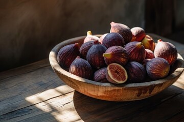 Obraz premium A wooden bowl filled with perfectly ripened figs, placed on top of a solid wooden table, A pile of ripe figs in a rustic wooden bowl, dappled in gentle morning light, AI Generated