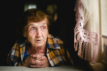 Portrait of a Senior Woman Seated at a Table. - 779665515
