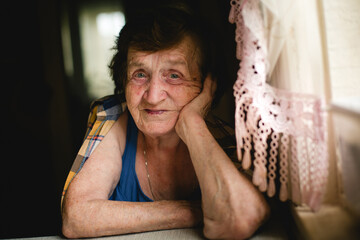 Tableside Portrait, Elderly Woman in Focus.