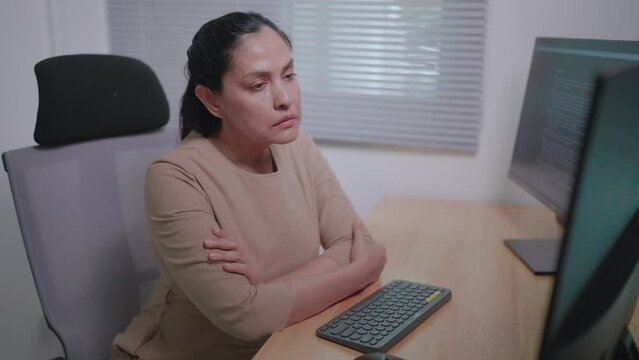 Freelance woman sitting and writing code she feels tired