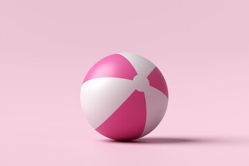 Inflatable beach ball on pink background. Summer holiday, vacation concept.