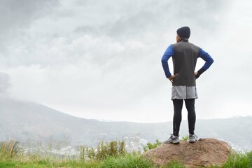 Runner thinking, fitness and man in nature for training , wellness or outdoor adventure for health. Athlete, back or sports person on mountain peak with idea or inspiration for exercise or workout