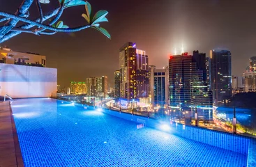 Poster Kuala Lumpur night scene cityscape,and illuminated swimming pool,Kuala Lumpur,Malaysia. © Neil